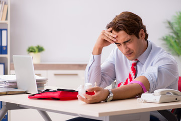 Man with first aid kit in the office