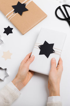 Female hands holding a gift package