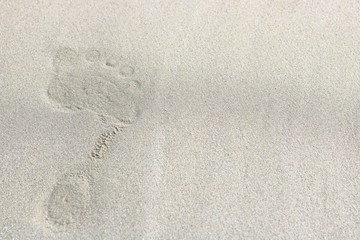 Top view of footprints on sand background, selective focus