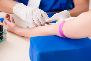 Young patient during blood test sampling procedure  