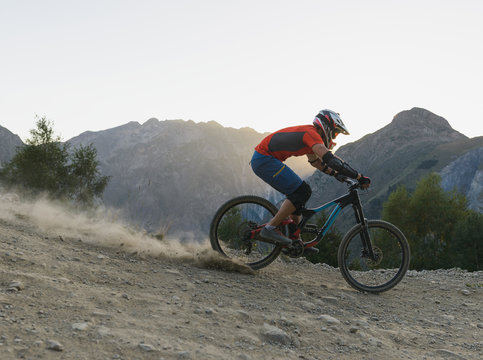 Man freeriding with high speed downhill alpine singletrack