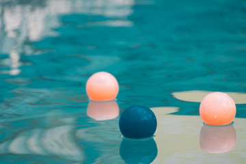Inflatable colorful ball floating in a swimming pool