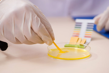 Chemist in the lab checking with ph strips