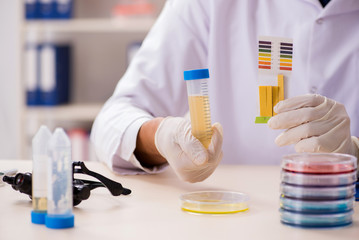 Chemist in the lab checking with ph strips