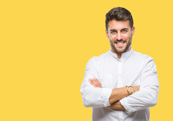 Young handsome man over isolated background happy face smiling with crossed arms looking at the camera. Positive person.