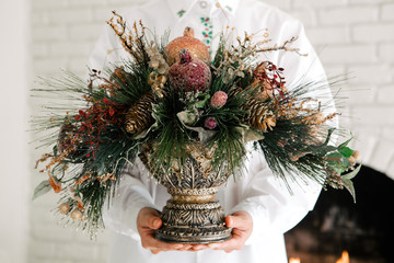 Woman hand holding beautiful vintage frosty Christmas decoration