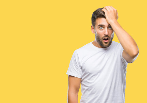 Young handsome man over isolated background surprised with hand on head for mistake, remember error. Forgot, bad memory concept.