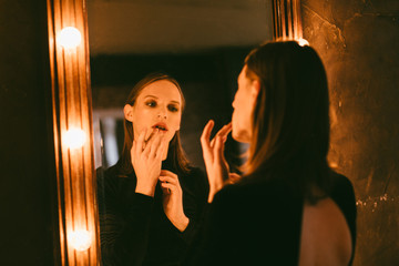 young androgyne man near the mirror