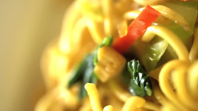 Balinese local fried noodle dish of Mie Goreng displayed on nutritious Banana leaf in Balinese vegetarian restaurant 