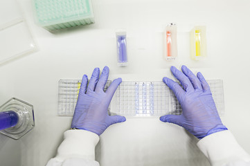 Female scientist using a pipette in a DNA laboratory