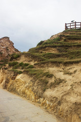 Low angle of yellow mountain and grass and telescope