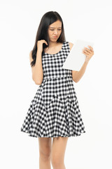 smiling beautiful  asian woman holding tablet computer isolated on a white background.