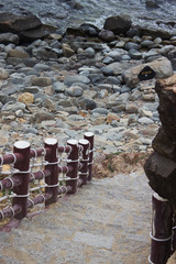 Stairs leading down pebble rock and ocean water line