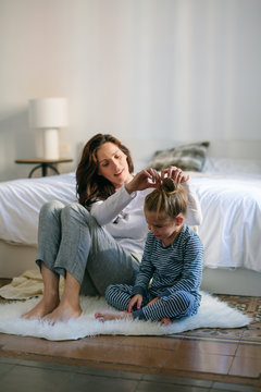 Mom anf daughter together at home in the morning. 