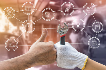 Mechanic hand checking and fixing a broken car in  garage.hand of mechanic with thumbs up and tool