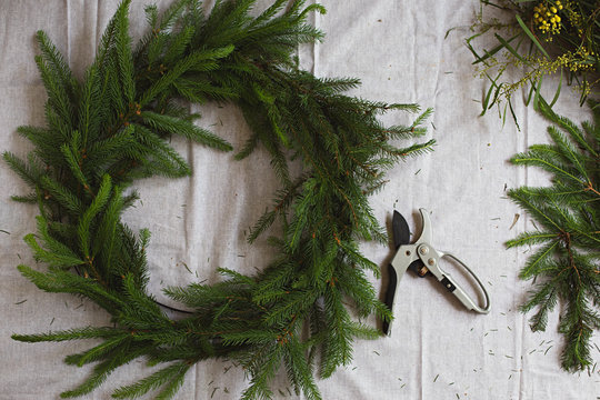 Creating a Christmas wreath from plant foliage and native Australian flowers.
