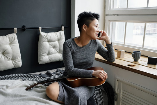 Young musician talking on phone
