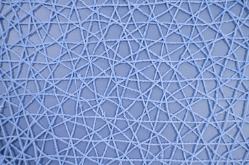 woven mesh of artificial material on blue background