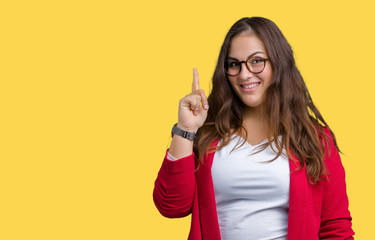 Beautiful plus size young business woman wearing elegant jacket and glasses over isolated background pointing finger up with successful idea. Exited and happy. Number one.