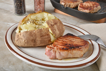 Fried pork cutlet with a baked potato