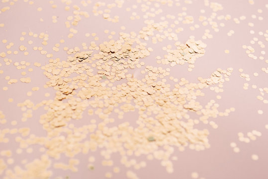 Golden confetti detail on a pink background
