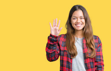 Young beautiful brunette woman wearing a jacket over isolated background showing and pointing up with fingers number five while smiling confident and happy.