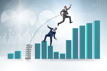 Businessman outperforming his competition jumping over