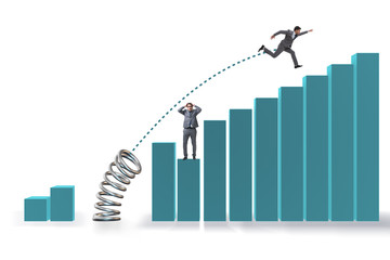 Businessman outperforming his competition jumping over