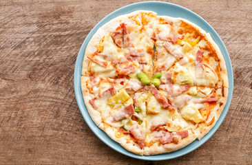 Hot pizza slice on wooden table