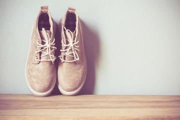 Close up vintage leather shoes accessory. Woman casual outfits with accessories on rustic wood background,Accessories with brown leather shoes on wooden table