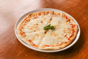 Hot pizza slice on wooden table