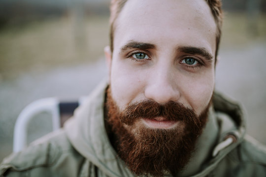 Portrait of young ginger man looking straight to camera