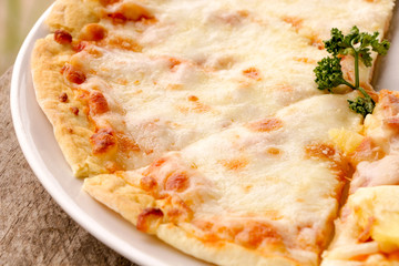 Hot pizza slice on wooden table