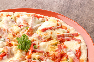 Hot pizza slice on wooden table