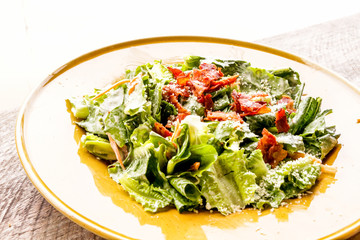 Caesar salad on wooden table