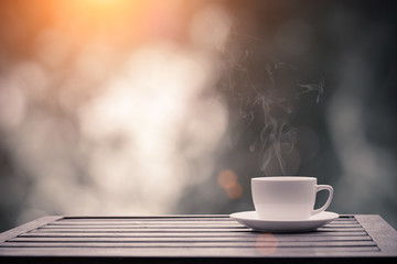 Coffee espresso on wood table nature background in garden,warm tone