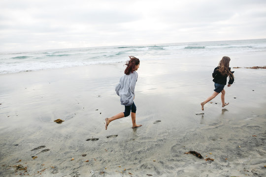 Girls running together on beach