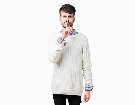 Young handsome man wearing winter sweater over isolated background asking to be quiet with finger on lips. Silence and secret concept.
