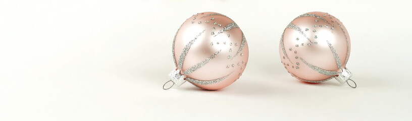 Christmas banner background from two pink  Christmas balls on white background . Xmas composition of New Year's Christmas balls. Winter holiday concept.Flat lay. Top view. Copy space