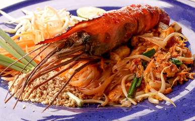 Hot Pad thai with shrimp on wooden table