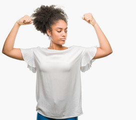 Young afro american woman over isolated background showing arms muscles smiling proud. Fitness concept.