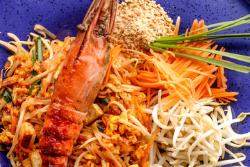 Hot Pad thai with shrimp on wooden table