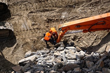 New York City, New York, USA: Workmen examining machinery used for breaking up Manhattan schist...