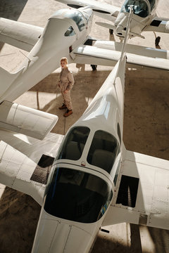 Woman in hangar with airplanes