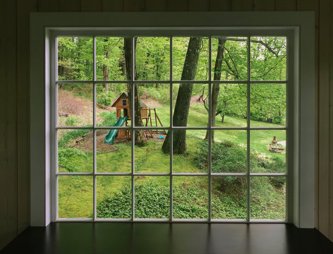 Spring View of Swing Set in Backyard