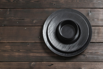 Fototapeta premium black plates on wooden background