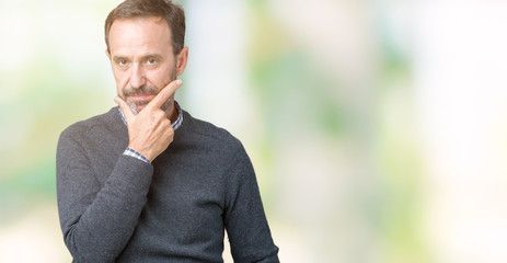 Handsome middle age senior man wearing a sweater over isolated background looking confident at the camera with smile with crossed arms and hand raised on chin. Thinking positive.