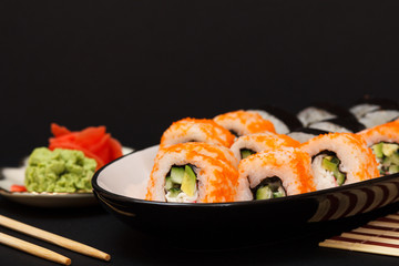 Uramaki California. Sushi rolls and pickled ginger and wasabi.