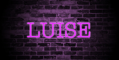 Fototapeta na wymiar first name Luise in pink neon on brick wall