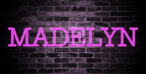 Fototapeta na wymiar first name Madelyn in pink neon on brick wall